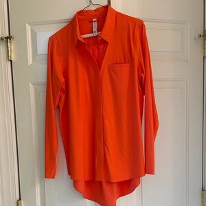 Athleta high low blouse in vibrant orange.